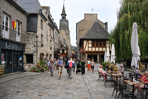 Dinan, France, September 8, 2023 - Rue de l'Horloge with the clock tower (Tour de l'Horloge) in the medieval old town of Dinan, Brittany, France.