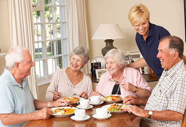 istock Group Of Senior Couples Enjoying Meal Together With Home Help 171240876
