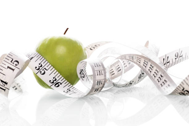 istock Green Apple and Tape Measure 171241478
