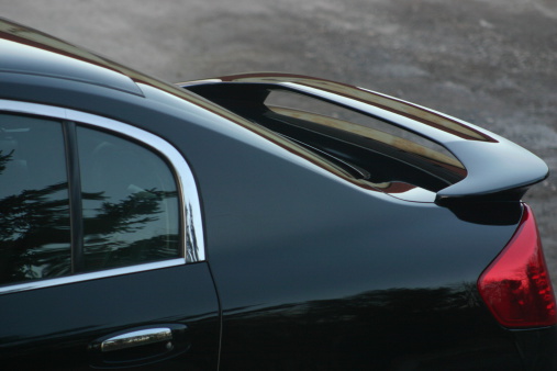 Rear deck spoiler on an executive class sports sedan