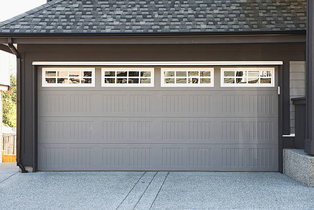 Grey and white garage door with windows stock photo