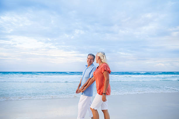 istock Senior couple enjoying a walk on the beach 171242509