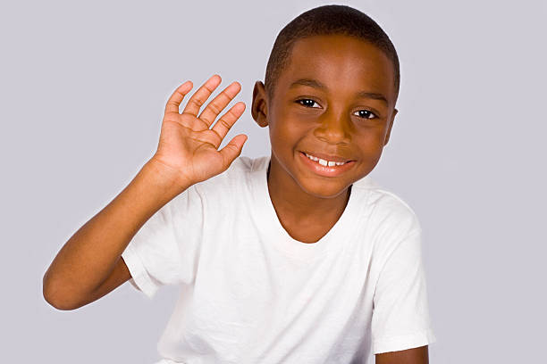 waving boy african american boy with friendly greeting kid waves stock pictures, royalty-free photos & images