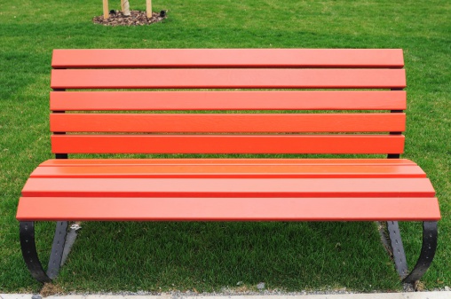 Fresh painted red bench in the park