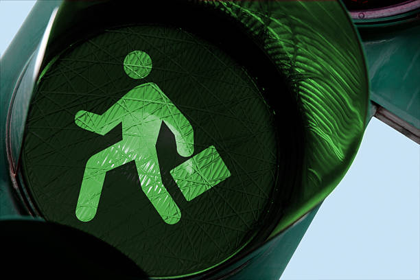 Businessman on the run "Icon of a running businessman, on a green stoplight.Other traffic lights in:" green light stoplight photos stock pictures, royalty-free photos & images