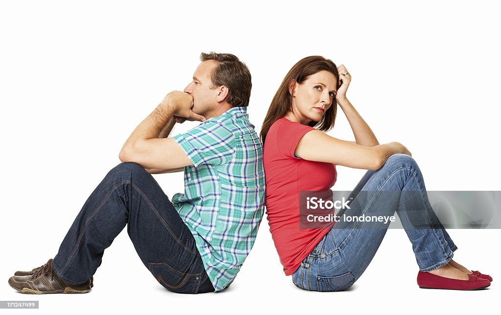 Mature Couple Sitting Together - Isolated Side view of mature couple sitting back to back after a conflict. Horizontal shot. Isolated on white. Couple - Relationship Stock Photo