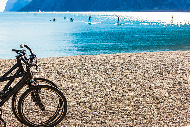 des vélos et des planches à voile à lac de garde - water surface european alps mountain valley photos et images de collection