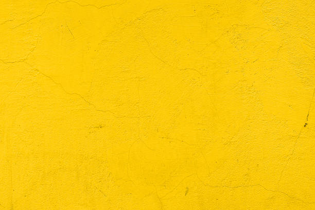 A background of a plain yellow wall Cracked yellow painted wall yellow stock pictures, royalty-free photos & images