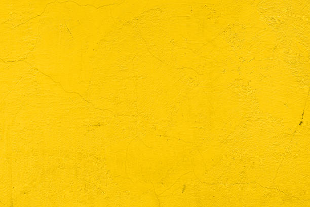 a background of a plain yellow wall - sarı stok fotoğraflar ve resimler