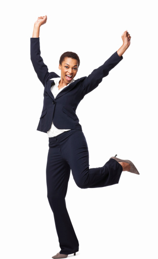 Full length portrait of an ecstatic African American female executive celebrating success. Vertical shot. Isolated on white.