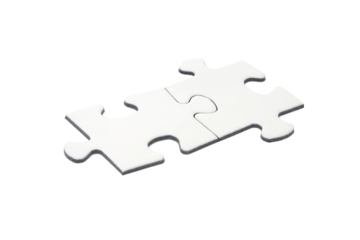 Two connected blank puzzle pieces isolated on a white background.