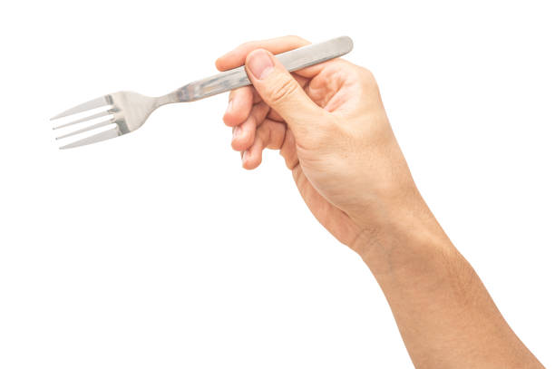 istock isolated of a man's hand holding a silver steel fork. 1712481230