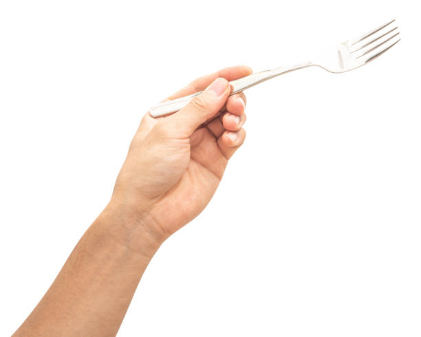 istock isolated of a man's hand holding a silver steel fork. 1712481740
