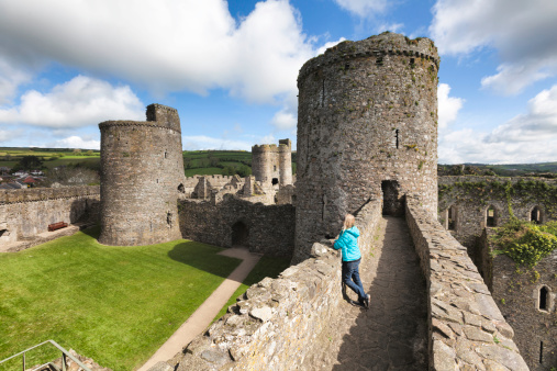 Woman admiring this fine example of a norman castle.