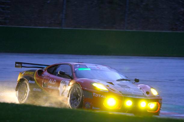 Ferrari F430 GT race car at the Spa racing track "Spa, Belgium - July 31, 2010: AF Corse Ferrari F430 racing on the track of Spa Francorchamps during the 2012 24 hours of Spa at night." ferrari ferrari f430 italian culture action stock pictures, royalty-free photos & images