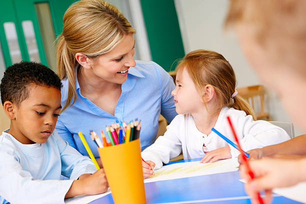 istock Children with teacher drawing in play room 171248419