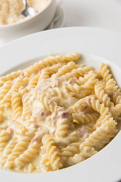 Fusilli Carbonara "Fusilli pasta (twisted pasta) with onion, olive oil, bacon, egg, pepper, parmesan and pecorino cheese" twisted bacon stock pictures, royalty-free photos & images