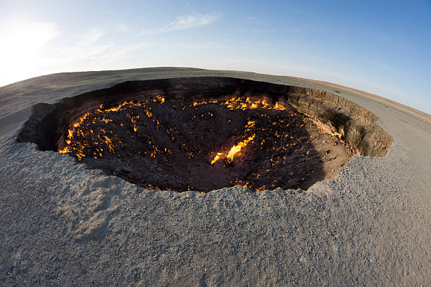 Burning black surface of Darbaza Gas Crater in Turkmenistan stock photo