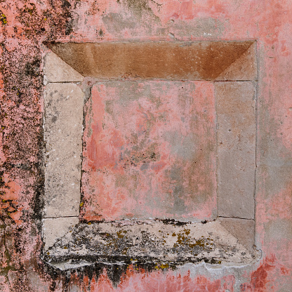 Grunge square frame in wall which can be used as a background.