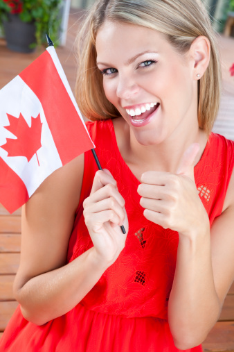 Female holding a Canadian flag outdoors