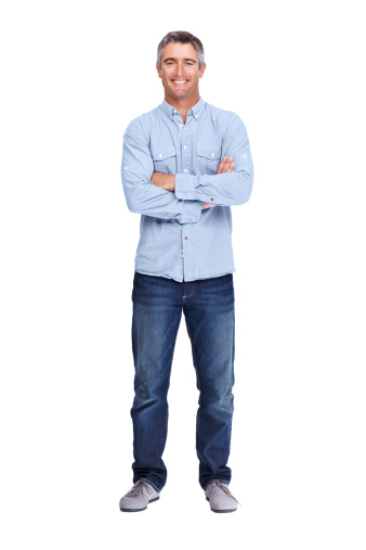 Full-length of a mature man standing on a white background with his arms folded