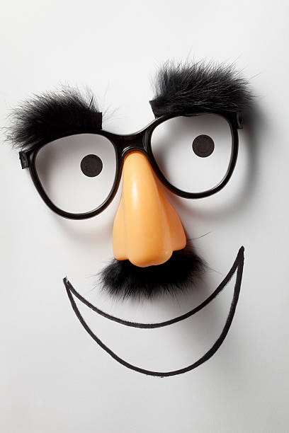 Smile. Funny glasses. Funny glasses resting on the drawing of a face. groucho marx disguise stock pictures, royalty-free photos & images