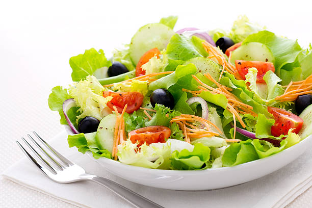 istock Fresh green salad with a fork in a white bowl 171251082