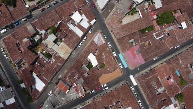 Aerial flyover: Geometric shape of quaint city streets of San Salvador