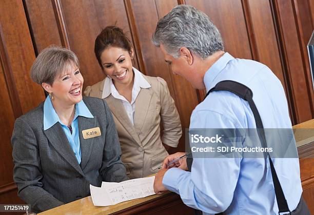 Hotel Front Desk Pracownikom Omawiania Pobytu I Bill Z Guest - zdjęcia stockowe i więcej obrazów Hotel