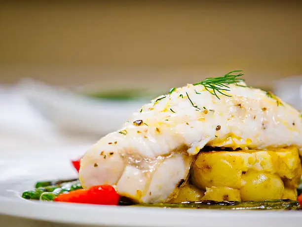 Pan fried monkfish tail with grilled beans,cherry tomato and crashed garlic potato with garlic dill butter sauce