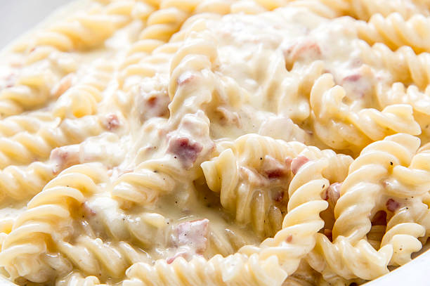 Fusilli Carbonara "Fusilli pasta (twisted pasta) with onion, olive oil, bacon, egg, pepper, parmesan and pecorino cheese" twisted bacon stock pictures, royalty-free photos & images