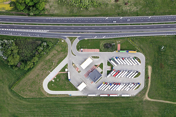 Aerial view of a lorry park beside a main road stock photo