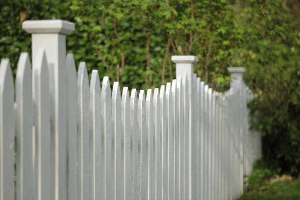 Full frame view of wire fence brightly lit, black background.