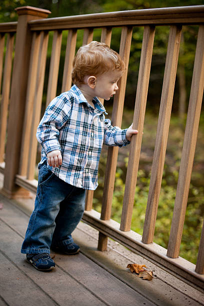 istock Toddler Boy Standing on Deck Outdoors, Autumn Day 171254461