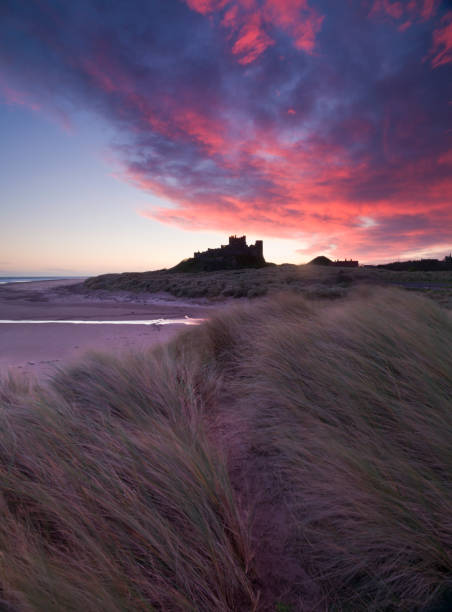 Bamburgh Castle Sunrise Sunrise over Bamburgh Castle on the Northumberland Coast Bamburgh stock pictures, royalty-free photos & images