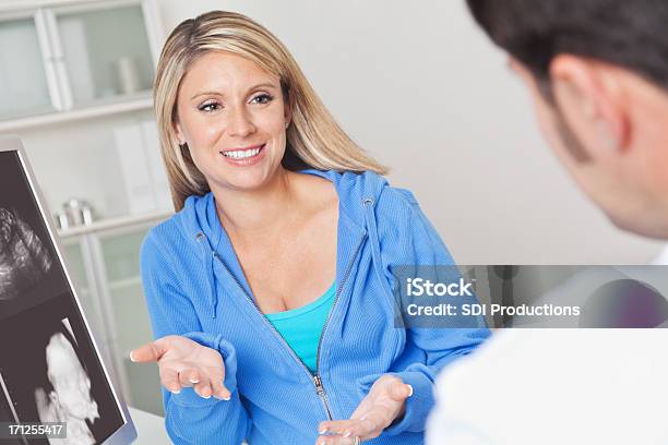Pregnant Woman Asking Doctor A Question About Her Sonogram Stock Photo - Download Image Now