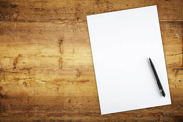 Planning Directly above view of a old wooden table , papers and a pen on it white shabby chic desk stock pictures, royalty-free photos & images