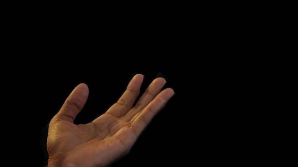 istock Human hand praying, raising at Church. 1712576488