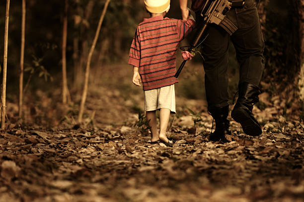 Military father and son walking .