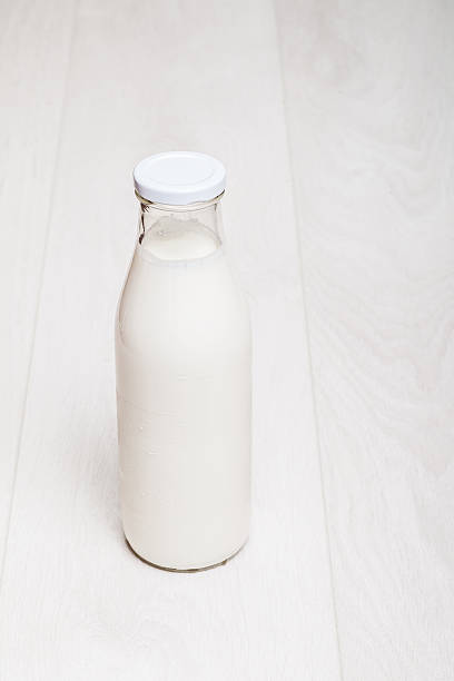 istock milk bottle on wooden background 171258485