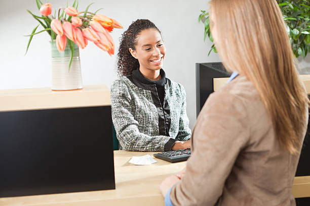 istock Friendly Teller Helping Customer in Retail Banking Window Counter Hz 171258519