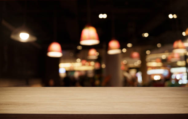 istock Mock up for space. Empty dark wooden table in front of abstract blurred bokeh background of restaurant . can be used for display or montage your product 1712606022