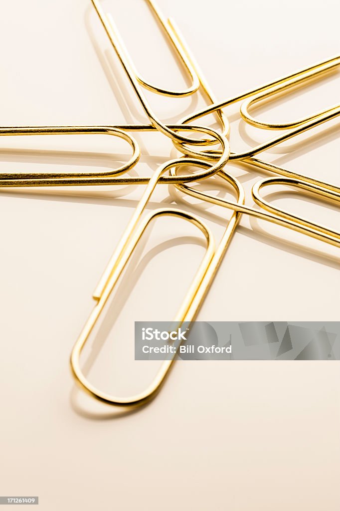 Connected Paper clips connected to central ring, Concept for unity or teamwork. Attached Stock Photo