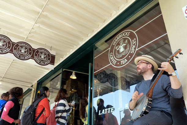Banjo musician play in front of Starbucks stock photo