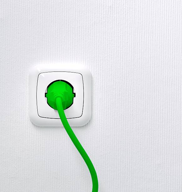 Power outlet with green lead and plug Power outlet with green plug - Green Energy Concept two pin plug stock pictures, royalty-free photos & images