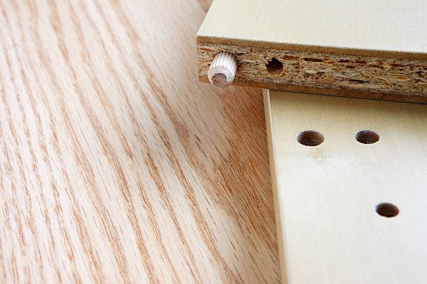 Prefabricated Furniture Dowel. Predrilled holes and dowel pins are used to align and ease assembly of prefabricated furniture. pressboard stock pictures, royalty-free photos & images