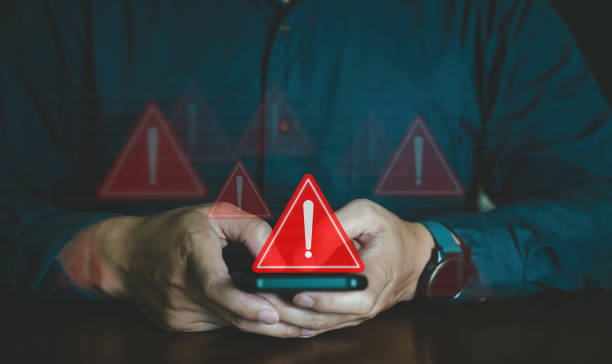 istock Emergency warning alert alarm on Smartphone, Data network protection, Virus alarm with people using computer. 1712624012