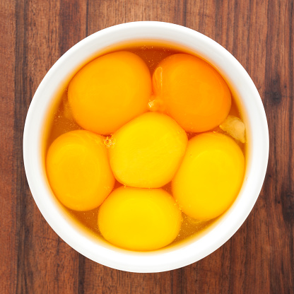 Top view of white bowl full of egg yolks