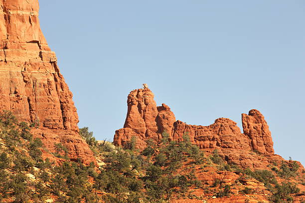 Desert red rock butte formation in the shape of the Charles M. Schulz Peanuts character Snoopy laying on top of his doghouse.  Sedona, Arizona, 2012.
