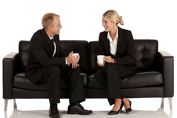 istock Business couple sitting on couch having coffee 171263382